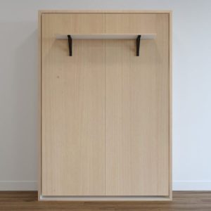 Space-saving light wood folding double bed integrated into a wall unit. Ideal for small rooms.