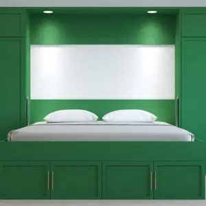space-saving green Murphy bed disguised as a cabinet in a modern room. Wall bed solution for small spaces.