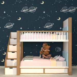 Space-themed wooden bunk bed with storage stairs, featuring a cosmic wallpaper design, pink bedding, and a child hugging a teddy bear on the lower bunk.