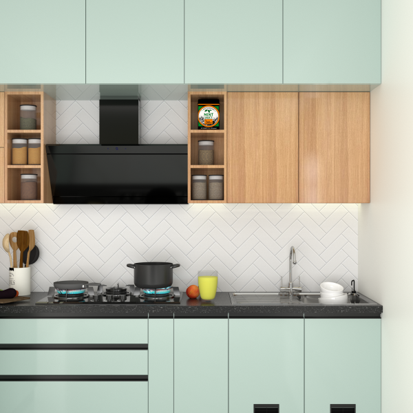 Modern dual-tone kitchen design with pastel green cabinets, wooden upper storage, black chimney hood, and a white herringbone backsplash.